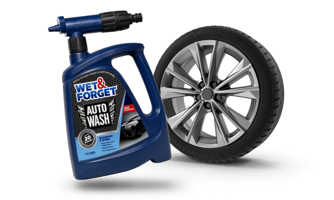 Wet & Forget Auto Wash product pictured next to car's wheel with a cleaned wheel rim.
