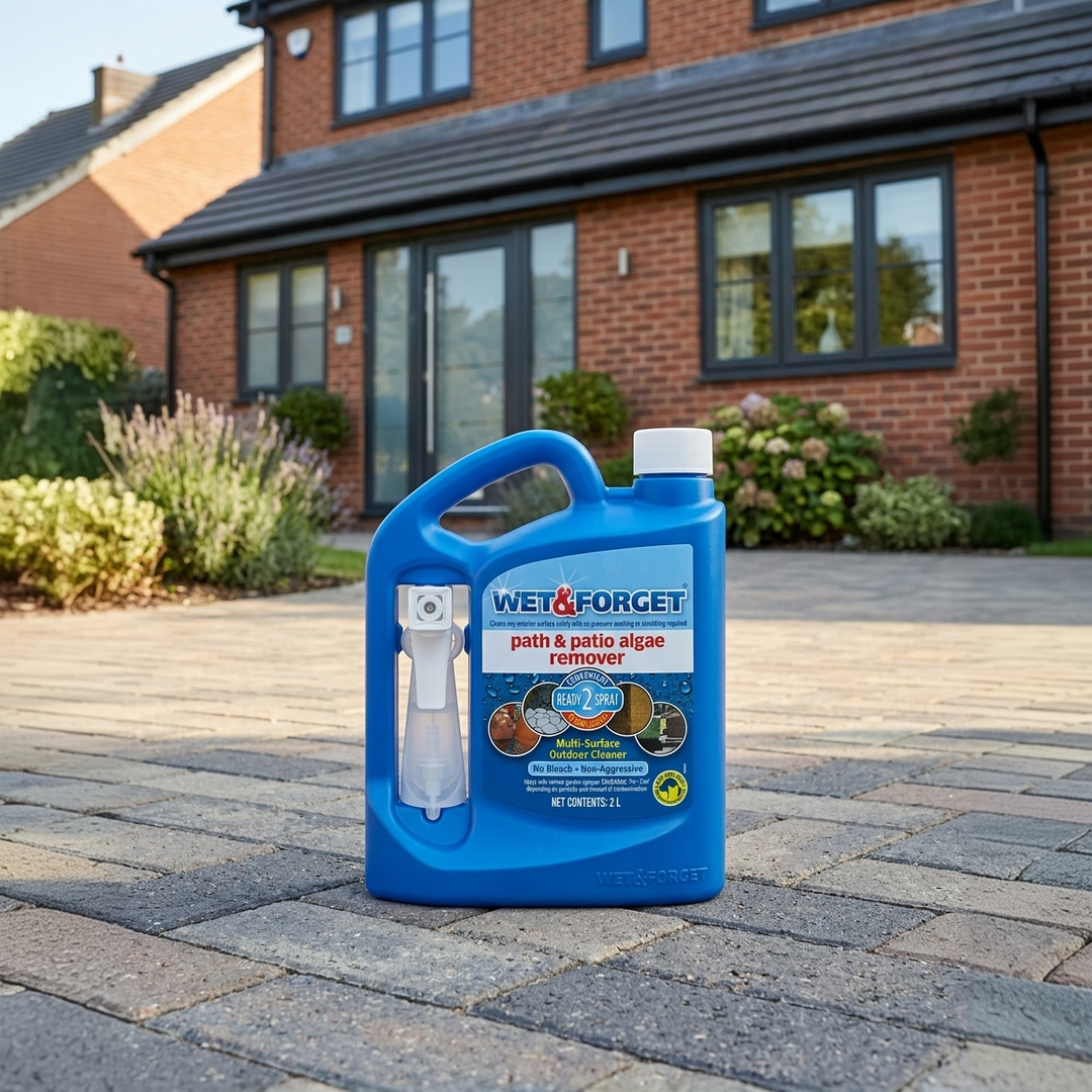 Blue Wet and Forget 2L Outdoor Product positioned on a cleaned Driveway in front of a modern house.